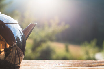 metal teapot on nature background
