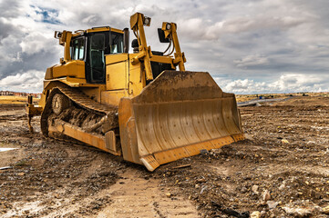 Excavator working on a muddy construction site