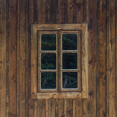 Old wooden window with shutters on wooden wall. The old window of old wooden house on countryside . 