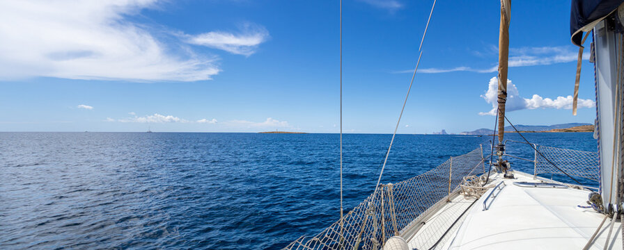 Panoramic of the larboard of a sailboat in the mediterranean sea. Vacation, summer and adventure concept. Calm ocean while sailing.