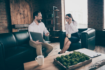 Photo of two business people partners professionals aged assistant show lady chief notebook online presentation project formalwear clothes sit couch modern office indoors