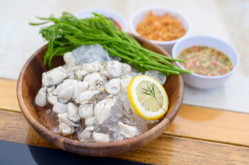 Fresh oysters served in a plate with thai spicy seafood sauce