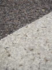 Closeup of a tar or asphalt pavement texture with white lines painted on asphalt road