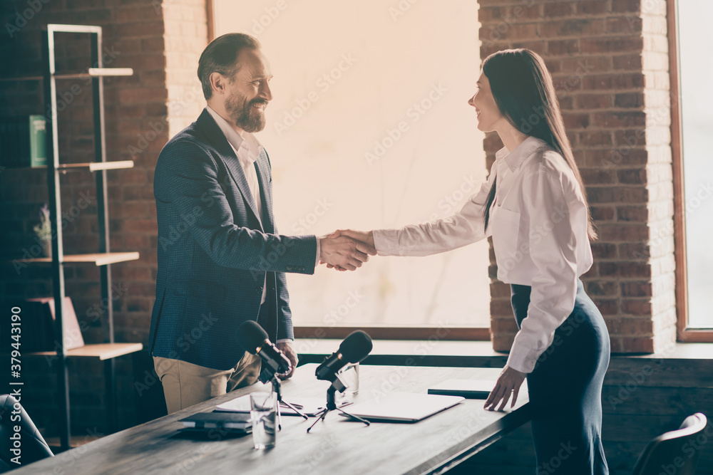 Sticker Profile photo of two people businessman business lady partnership doctors colleagues press conference mass media shake arms greeting reportage microphone on table office indoors