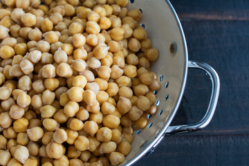 Soaked Chickpeas Drained in a Colander: Dried garbanzo beans that have been soaked in water and drained in a colander