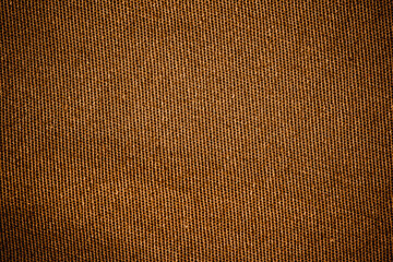 Brown textile fabric texture closeup photo background.