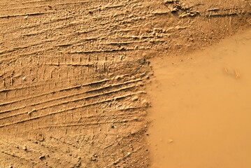 mud, puddle and wheel tracks close-up, background