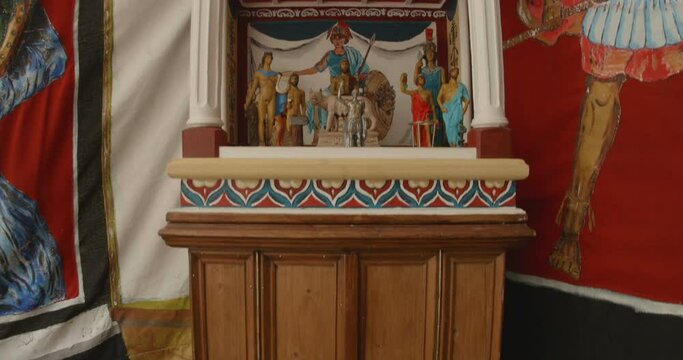 Roman Empire worshiping small shrine.