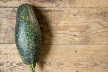 Top view fresh harvest, large squash on a wooden surface. Copy the space to the right. Selective focus, shallow depth of field