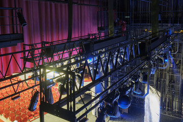Technical equipment at the backstage of theater. Stage spot lighting rigging structure for a musical theater events - obrazy, fototapety, plakaty