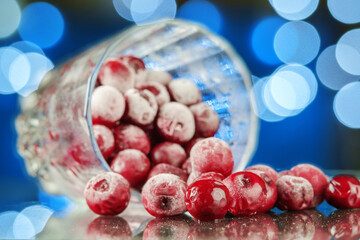 Frozen cherry in the glass reflecting on the surface with blurred background