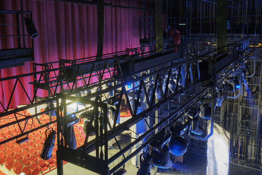 Technical Equipment At The Backstage Of Theater. Stage Spot Lighting Rigging Structure For A Musical Theater Events