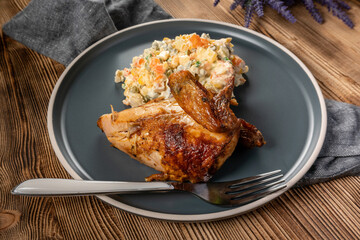 Roast chicken served with russian traditional salad.
