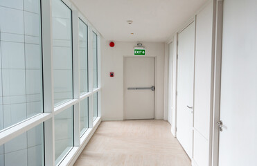 Green emergency exit sign showing the way to escape. Fire exit in the building.
