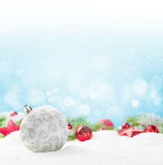 Christmas greeting card with decor in snow