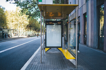 Industrial bus stop with Lightbox on side for text advertising on sidewalk near road in town,...