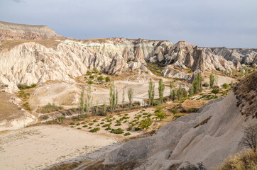 Unique colorful sandstone rock formations in the Rose Valley. Central Anatolia, Cappadocia, Turkey