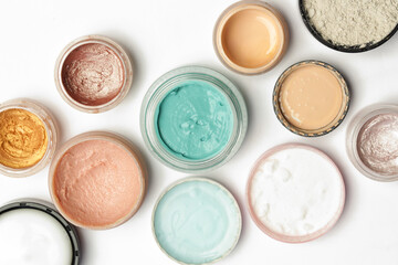 Set of make up and cosmetic products - top view of decorative cosmetic containers isolated on white backgroiunds