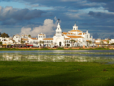 El Rocio village and its church with cloudy sky with the marh area of La Rocina in the front
