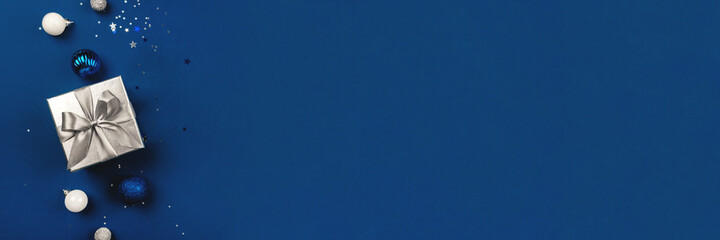 Blue Christmas background of gift box and decorations. The concept of the winter holidays. Flat...