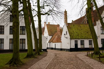 Foto op Canvas The tranquil Begijnhof ten Wijngaard, Brugge, West Flanders, Belgium: now a Benedictine convent  formerly a "beguinage" for pious women © Will Perrett