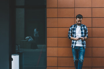 Young male hipster using smartphone