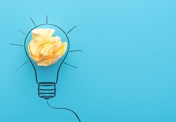 Sketch lamps and crumpled yellow paper on a blue background. Concept picture about office work and   creativity ideas.  - obrazy, fototapety, plakaty