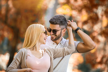 Romantic couple enjoying golden autumn fall season