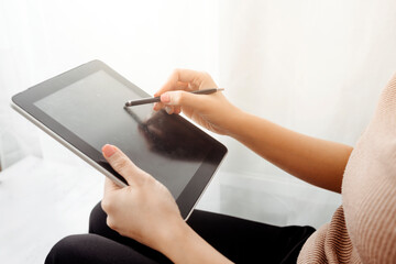 Businesswomen hands working with finances about cost and calculator and laptop with tablet, smartphone at office in morning light