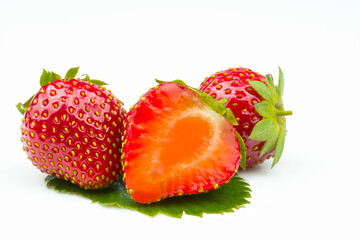 Sliced ​​fresh strawberries close-up isolated on a white background.