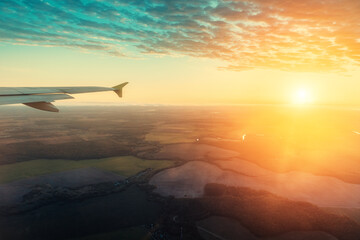 Colorful and picturesque sunset from the plane window during the flight.