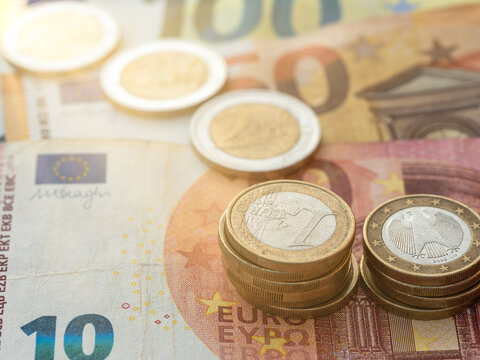 Close up view on euro coin stacks on euro bills