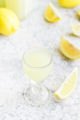 Italian traditional liqueur limoncello with lemon