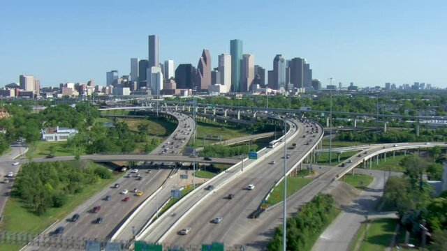 Wide aerial, highway leads to Houston skyline