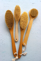 Brushes for dry body massage. wooden brushes with natural bristles on a light background