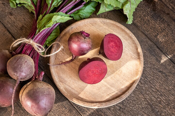 Cut up red beets with leaves on a table