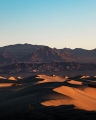 sunrise in the desert over sand dunes