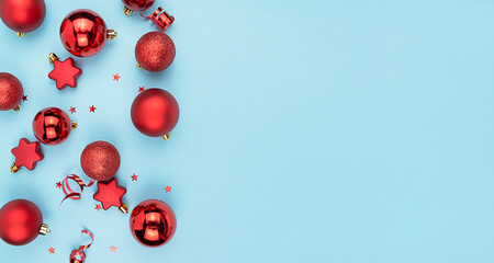 Naklejka na ściany i meble Christmas red balls and toys on a blue background. Christmas background. New year banner. Copy space.