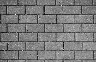 Paving slabs and stones pattern in running bond style, black and white colorless background of brick wall
