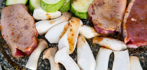 grilling mushrooms and meat on the stone