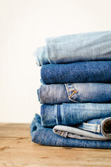 Jeans stacked on a wooden table