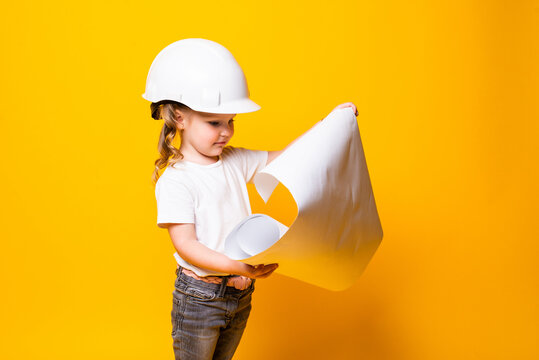 Little Girl Architect In The Construction Helmet With A Poster Isolated On Yellow Background