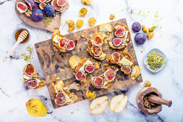 view of delicious freshly baked croissants with figs, pears, nuts and honey