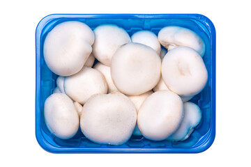 Fresh champignon mushrooms in a plastic container isolated on white