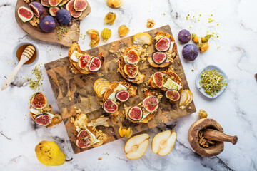 view of delicious freshly baked croissants with figs, pears, nuts and honey