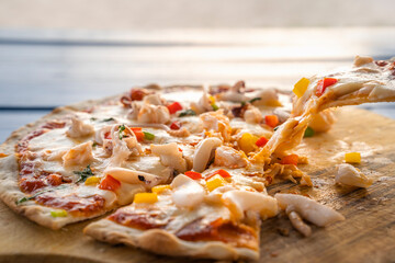 Close-up,scoop pizza from a wooden tray