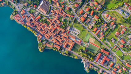 Aerial view from the drone of the landscape of a small town on the shores of lake Como, Italy. - obrazy, fototapety, plakaty