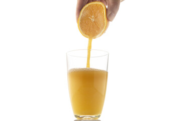 Squeezing an orange into a glass