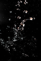 Splash of clear water on black isolated background.