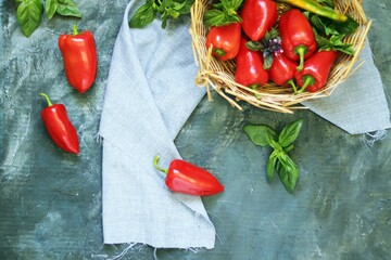 Ripe red sweet peppers on the table, basket, healthy food, home cooking
